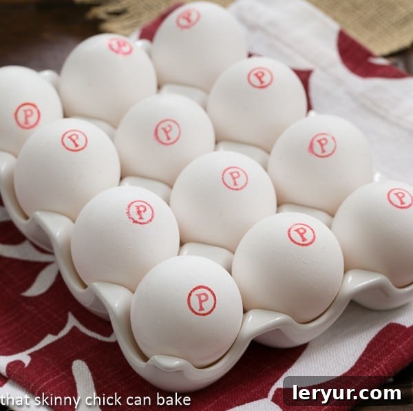 A carton of Safest Choice Eggs prominently displayed, featuring the distinctive red 'P' in a circle logo, emphasizing their pasteurized quality and safety.