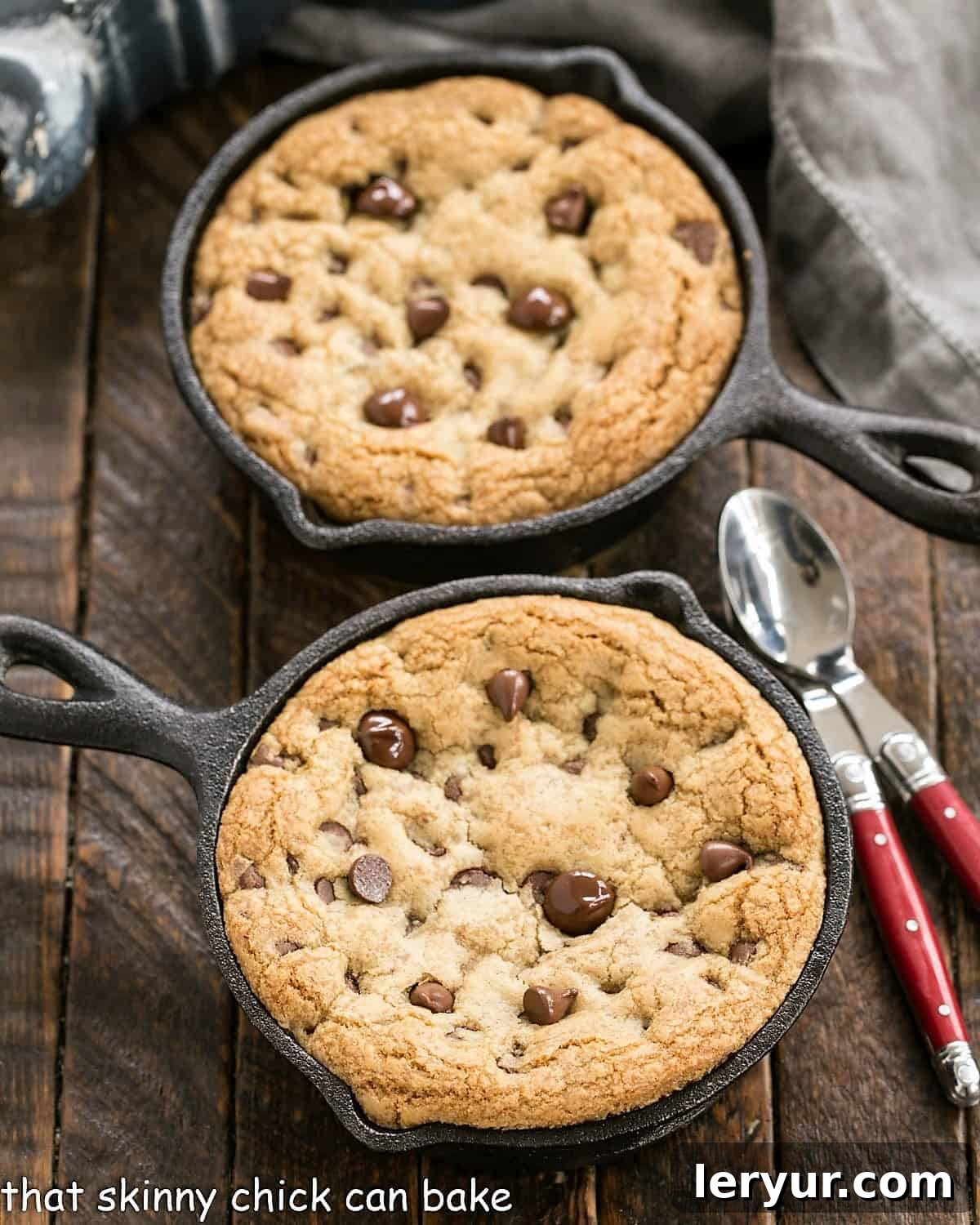 Homemade Pizookies Recipe - Big gooey pan cookies that are a cross between cookies and pan pizza! Overhead view of 2 pizza cookies in cast iron skillets, ready to be topped.