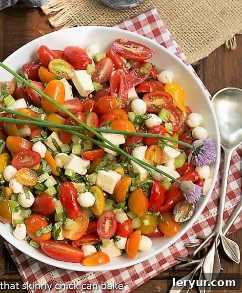 Overhead view of a beautifully arranged Caprese Salad, highlighting fresh mozzarella, tomatoes, and basil leaves