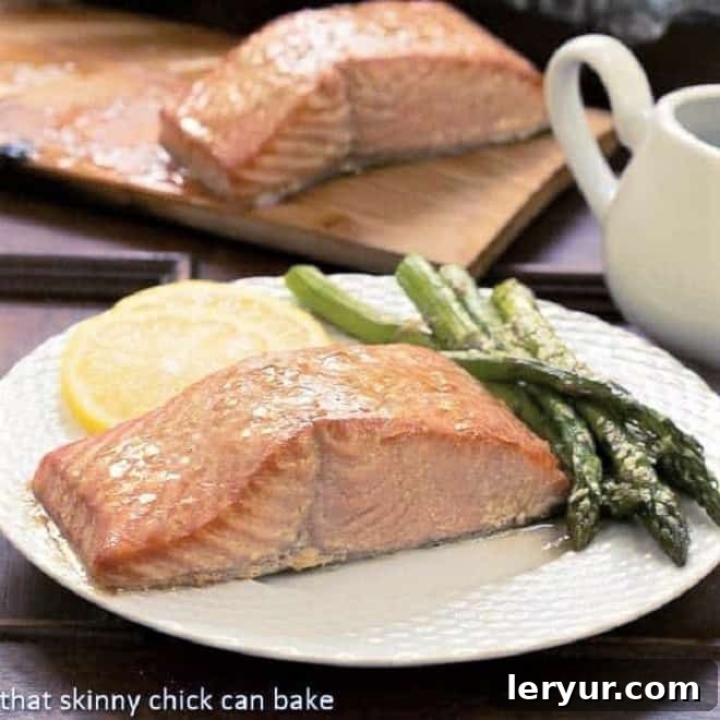 Grilled Cedar Plank Salmon on a white plate with asparagus