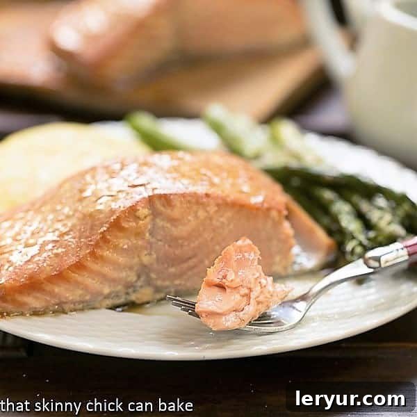 Grilled Cedar Plank Salmon on a plate i with a bite on a fork