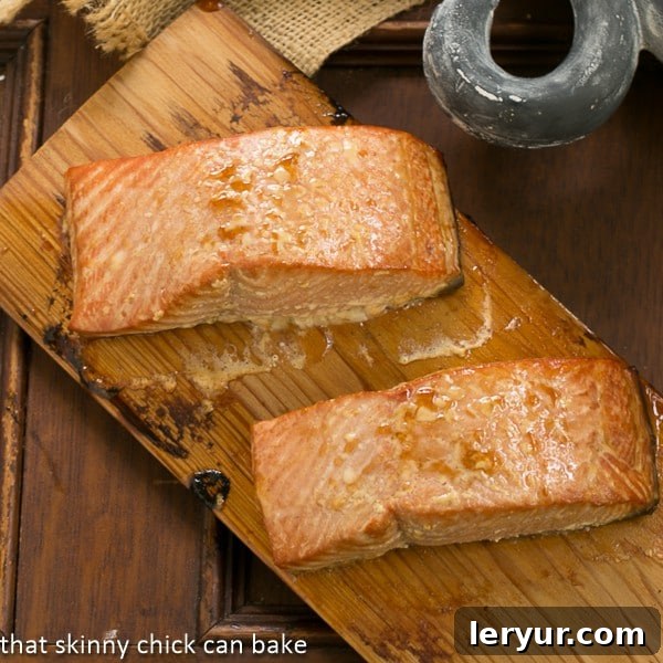  Two fillets of Grilled Cedar Plank Salmon on a cedar plank