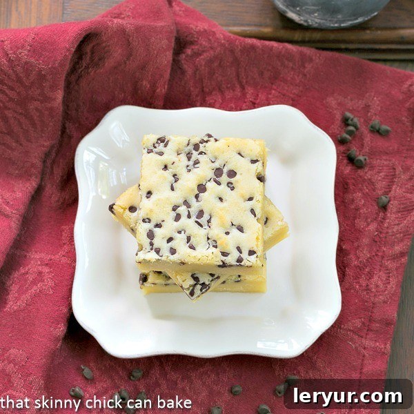White Chocolate Brownies: A Creamy and Chewy Delight Overhead view of several White Chocolate Brownies neatly stacked on a white dessert plate, ready to be served.