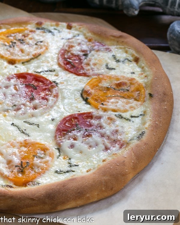 Pizza Margherita fresh out of the oven on a sheet of parchment.