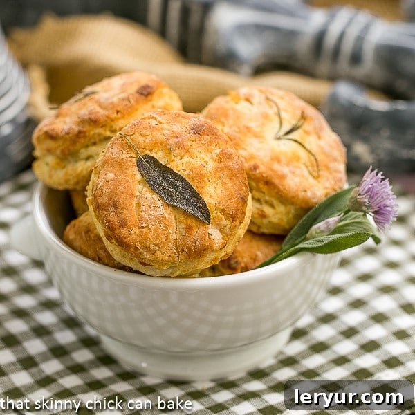 Herbed Buttermilk Biscuits - Tender, buttery biscuits with a boost of flavor from fresh herbs Herbed Buttermilk Biscuits in a bowl with a fresh herb garnish.