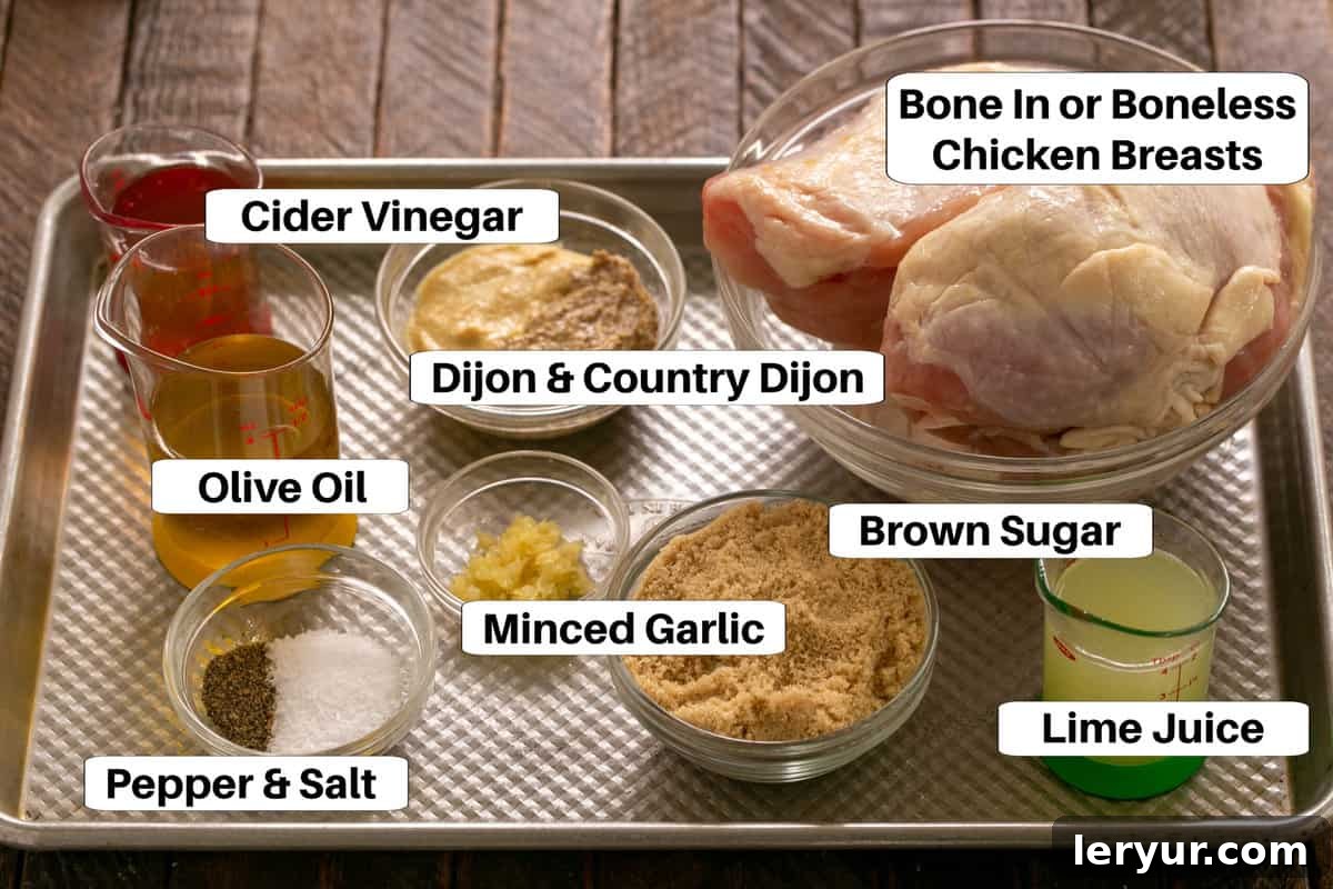 Zesty Mustard Lime Chicken 2 Chicken Marinade Ingredients laid out on a sheet pan with labels, including mustards, garlic, lime, and olive oil.