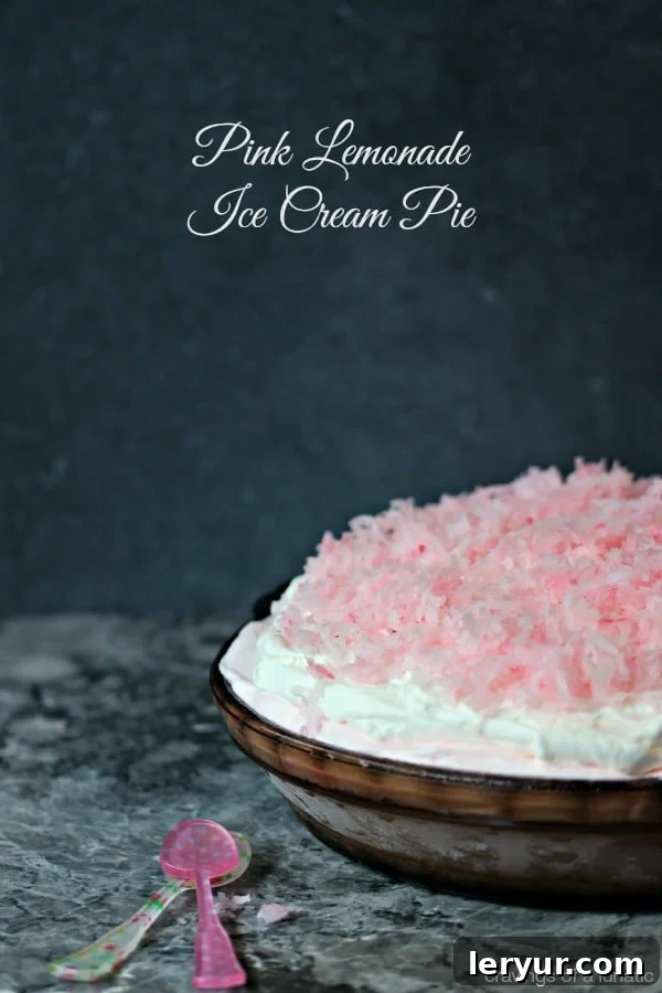 A slice of vibrant pink lemonade ice cream pie.
