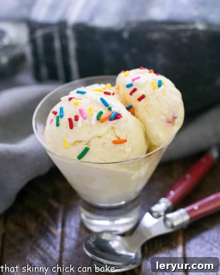 Scoops of golden cake batter ice cream with colorful sprinkles.