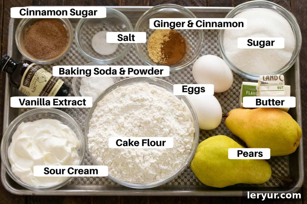 Pear and Sour Cream Loaf 2 Pear Bread Ingredients laid out on a sheet pan with labels, including flour, sugar, eggs, butter, pears, and spices.