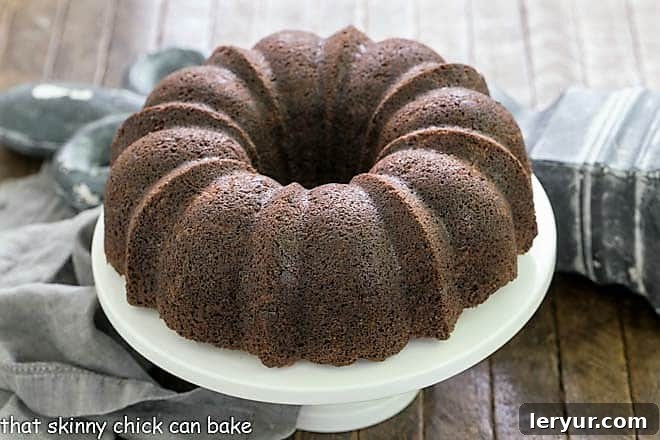 Chocolate Zucchini Bundt Cake on a white cake stand