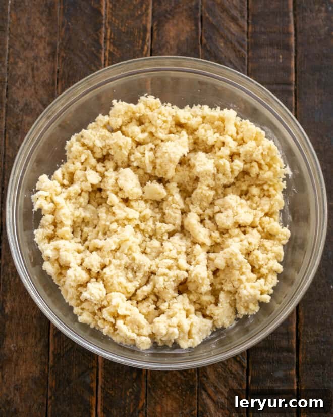 Golden Caramel Squares 6 Flour is added to the creamy butter mixture, and a portion is pressed into a baking pan.