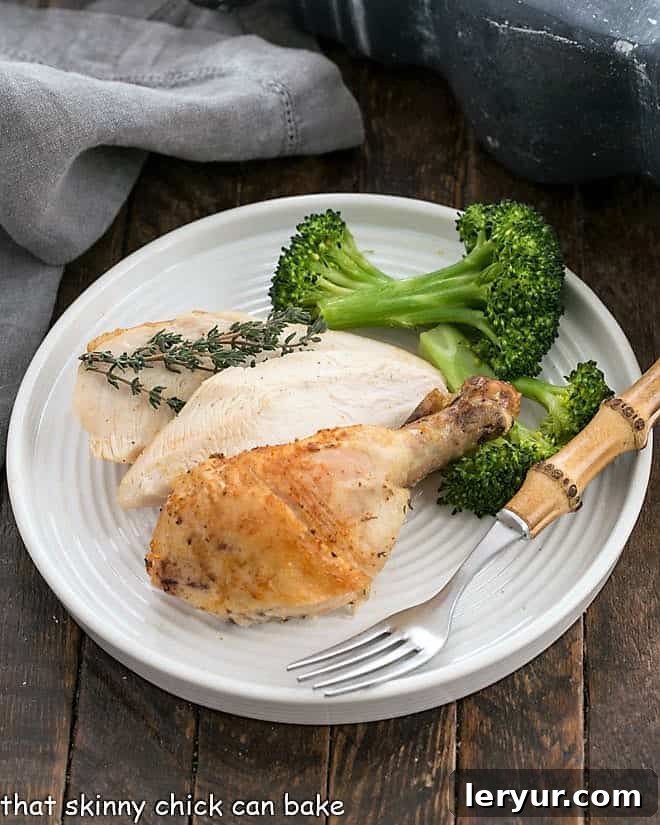 Rotisserie Chicken - Make this best roast chicken recipe at home! Overhead view of Rotisserie Style Chicken on a round white dinner plate.