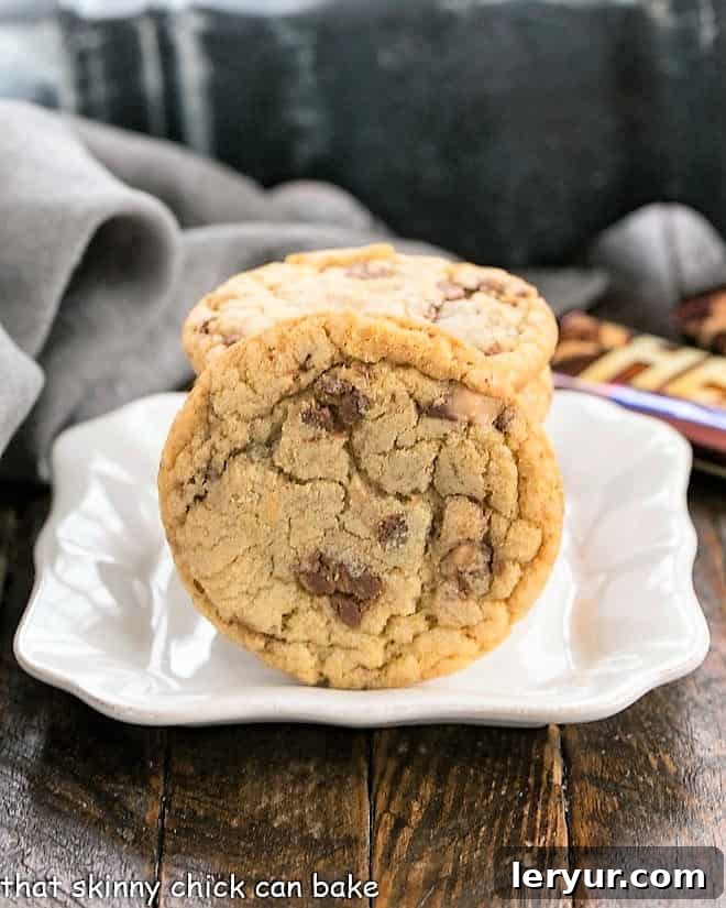 Golden Brown Butter Toffee Delights 2 Brown Butter Toffee Cookies on a small square ceramic plate, ready to be enjoyed.