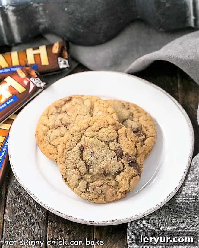 Brown Butter Cookies with Toffee - loaded with chunks of toffee and enhanced with the nuance of nutty brown butter Brown Butter Toffee Cookies on a round white plate, showing their golden color and inviting texture.
