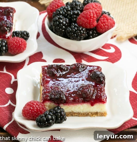 Twix Double Chocolate Dream Cookies 7 Colorful Berry Topped Cheesecake Bars, a delightful dessert from That Skinny Chick Can Bake.