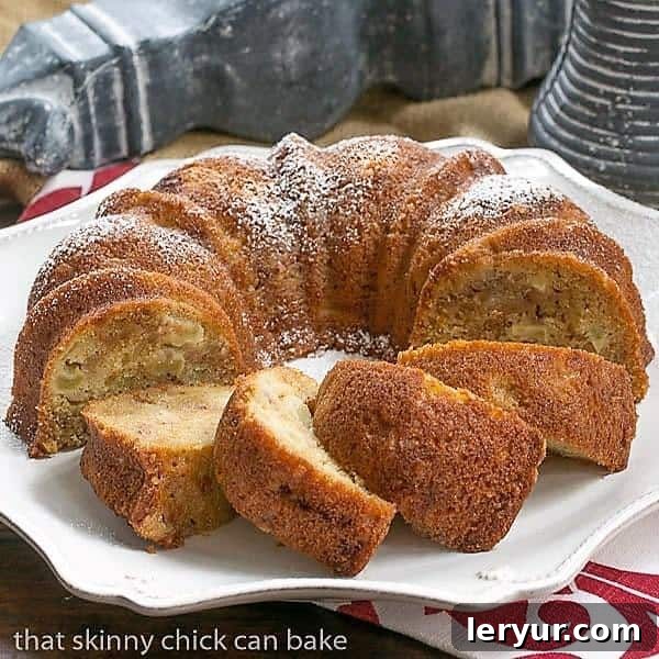 Apple Ginger Coffee Cake - A moist, delectable brunch, breakfast or dessert recipe! Full of autumn spices and crystallized ginger. A slice of Apple Ginger Coffee Cake with streusel on top, presented on a ceramic platter