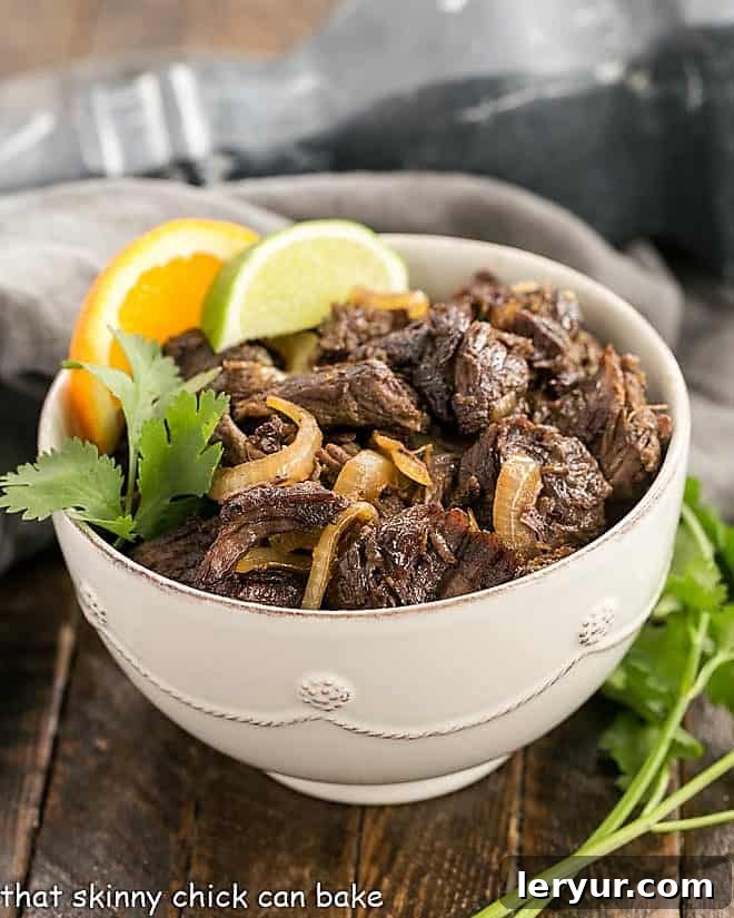 Vaca Frita - Scrumptious Cuban Shredded Beef Scrumptious Cuban Shredded Beef 45 degree angle view in a white bowl with a sprig of cilantro.