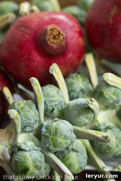 Fresh Brussels sprouts to be roasted, highlighting their vibrant green and firm texture Fresh Brussels Sprouts still attached to their stalk, showcasing their natural growth pattern.