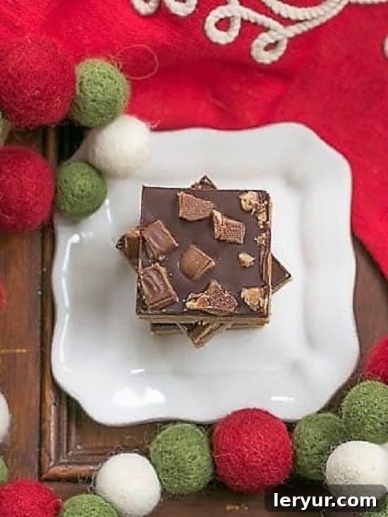 Overhead view of Candy Topped Toffee Bars on a square white plate, showing the rich chocolate and colorful toppings.