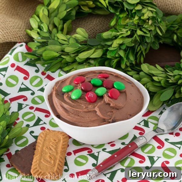 Brownie Batter Dip in a white bowl on a holiday napkin with two cookie dippers