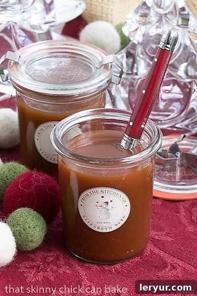 Homemade Microwave Caramel Sauce in glass jars, served with a red-handled spoon for decadent desserts.