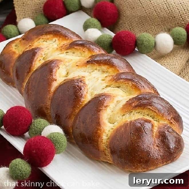 Authentic Swiss Butter Braid Recipe (Butterzopf) - Sweet Plaited Yeast Bread for Holidays and Special Occasions Beautifully golden-brown loaf of Swiss Butter Braid (Butterzopf) on a pristine white platter, showcasing its intricate braiding.