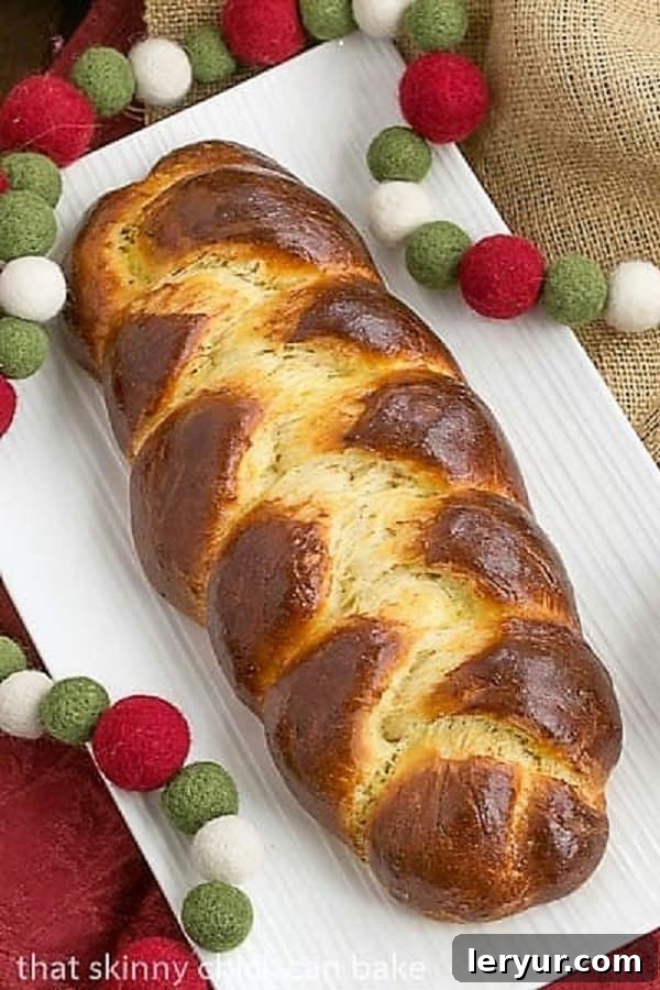 Ingredients for Swiss Butterzopf - Milk, Sugar, Butter, Eggs, Yeast, Salt, Flour Overhead perspective of a perfectly baked Swiss Butter Braid (Butterzopf), highlighting its symmetrical braids and golden crust on a white platter.