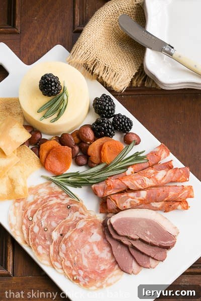 Overhead view of a fully loaded Charcuterie Platter, showcasing a variety of meats, cheeses, fruits, and nuts.