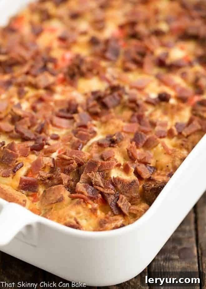 Simple Savory Bacon Egg Casserole 2 A large, golden-brown Easy Bacon and Egg Strata baked in a white ceramic casserole dish, ready to be served, highlighting its comforting and rustic appeal.