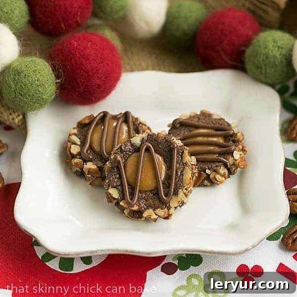 Elegant Turtle Thumbprint Cookies - rich chocolate bases filled with caramel and topped with pecans or chocolate. A selection of beautifully arranged Turtle Thumbprint Cookies on a square white plate, showcasing their rich chocolate, caramel filling, and pecan or chocolate drizzle toppings.