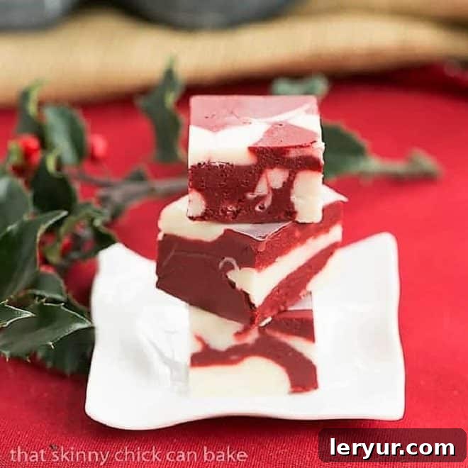 Easy Red Velvet Delight 2 Red Velvet Fudge on a small square rippled plate.