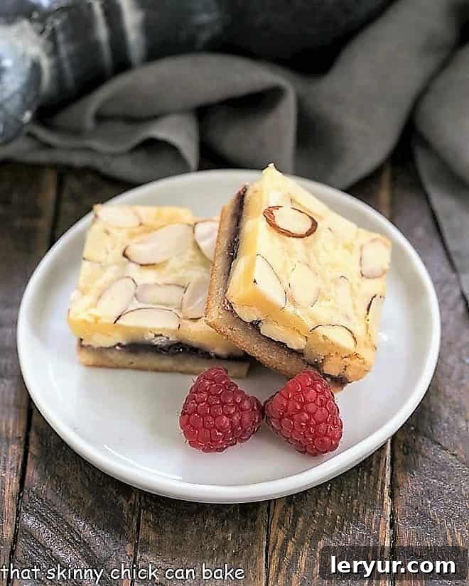 Irresistible Bar Cookie Delights 7 Raspberry Filled White Chocolate Bar on a round white plate with 2 raspberries