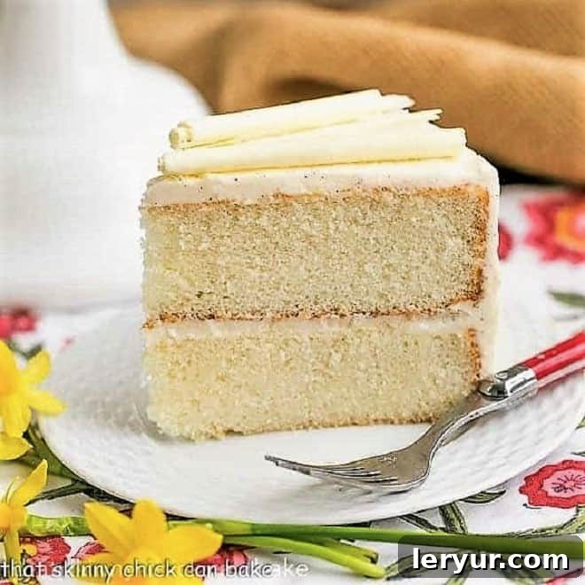 Tender white layer cake frosted with Vanilla Bean Buttercream, a bakery-worthy recipe.