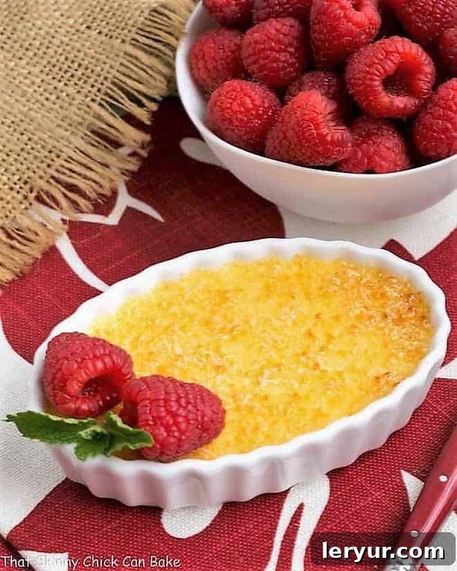 Classic Crème Brûlée - a fabulous vanilla custard topped with a thin layer of brittle, caramelized sugar Classic Crème Brûlée in a white ramekin with a raspberry garnish.