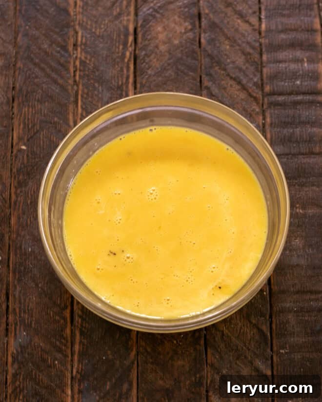 The Ultimate Crème Brûlée Guide 5 Whisked eggs in a Pyrex bowl.