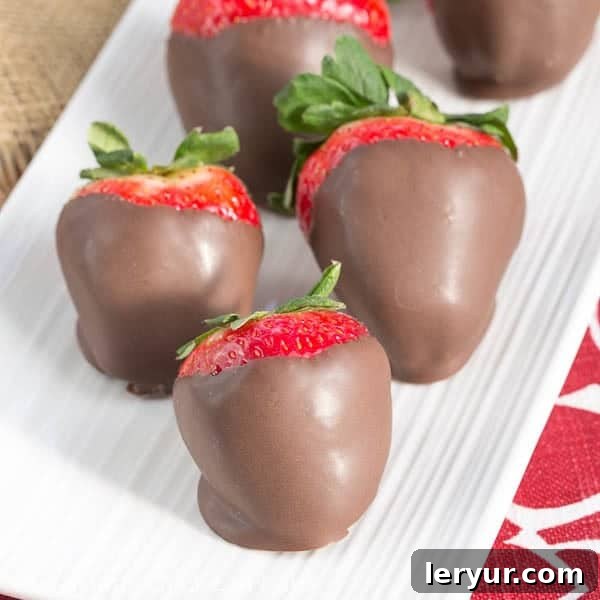 Mascarpone Filled Chocolate Covered Strawberries - a dreamy combination of berries, cream and chocolate! Mascarpone Filled Chocolate Dipped Strawberries on a serving tray