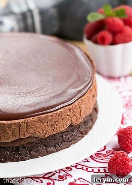 Decadent Frozen Chocolate Mousse Cake 2 Frozen Chocolate Mousse Cake on a white cake plate on a red and white napkin