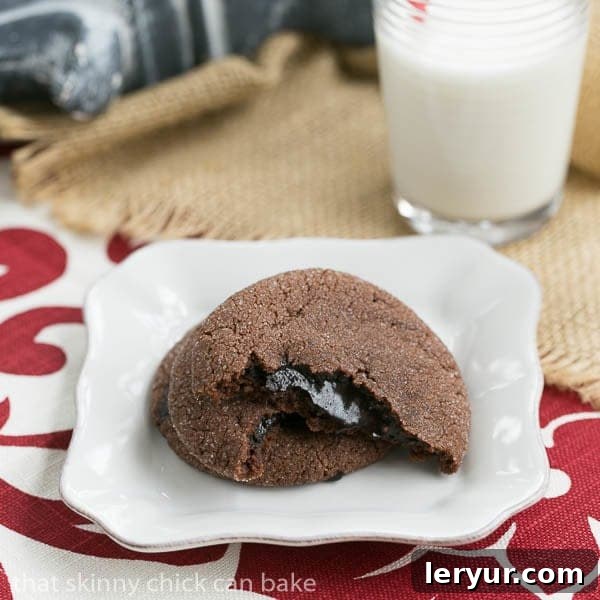Chocolate Lava Cookies - chocolate filled cookies with hot fudge sauce in the middle Chocolate Lava Cookies broken in half to expose fudge filling