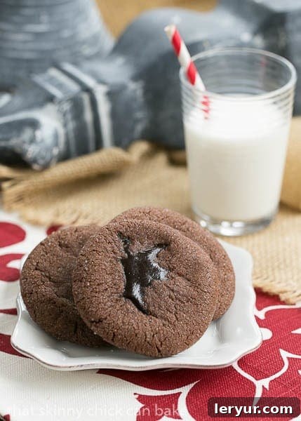Chocolate Lava Cookies - chocolate butter cookies filled with hot fudge sauce Chocolate Lava Cookies plated with a glass of milk