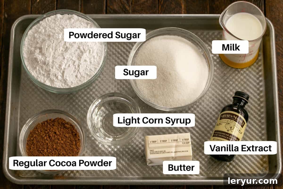 Timeless Chocolate Fudge Indulgence 3 Cocoa Fudge Cake Frosting Ingredients displayed on a metal sheet pan, showing butter, milk, sugar, cocoa powder, corn syrup, and powdered sugar.