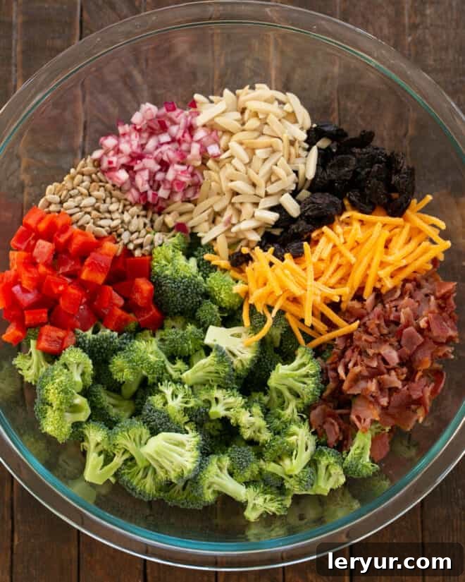 Sweet and Savory Broccoli Crunch Salad 4 Various broccoli salad ingredients in a large bowl.