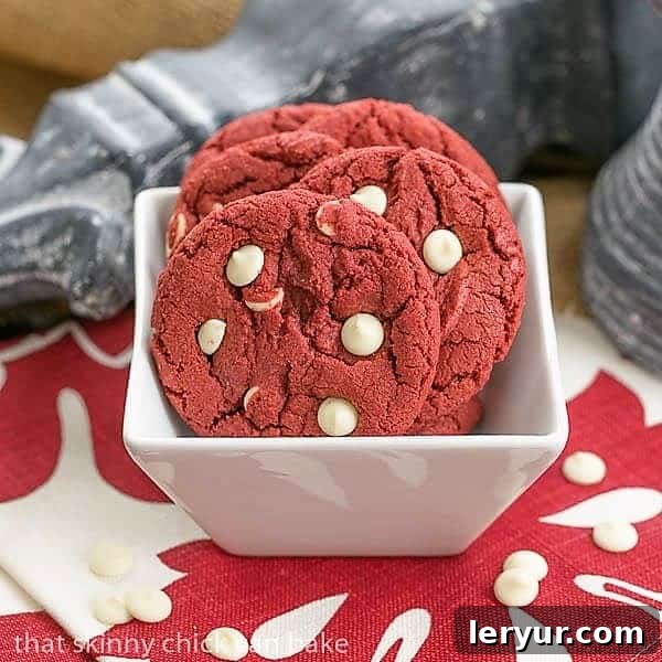 Red Velvet Cookies Recipe with White Chocolate Chips - A delightful twist on the classic cake A bowl of freshly baked Red Velvet Cookies with melted white chocolate chips, showcasing their vibrant color and inviting texture.