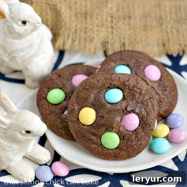 Close-up of Easter Candy Brownie Cookies on a white tray with colorful M&Ms scattered around, showcasing their chewy texture and rich chocolate color.