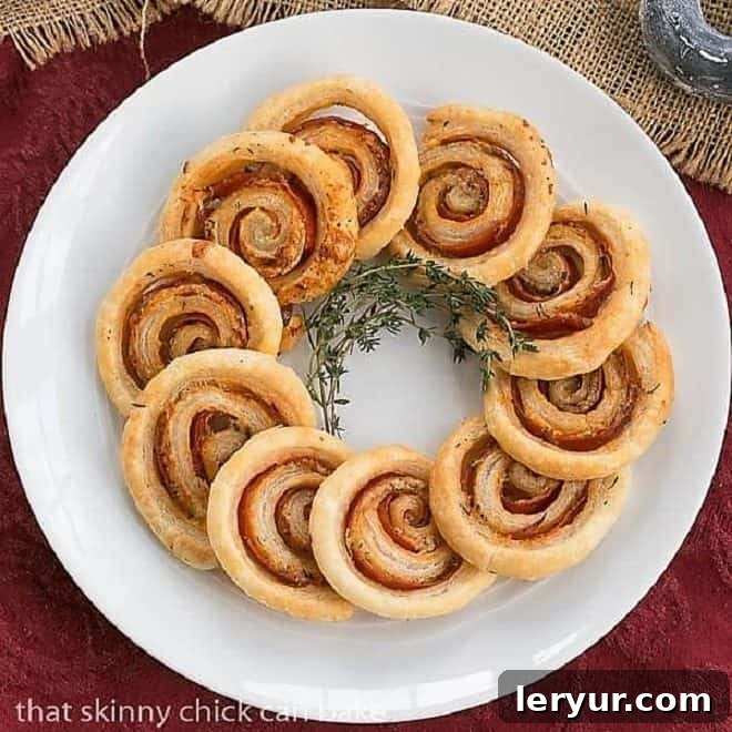 Overhead view of an array of golden Honey Mustard Pepperoni Pinwheels artfully arranged on a large, round, white platter, ready for serving.
