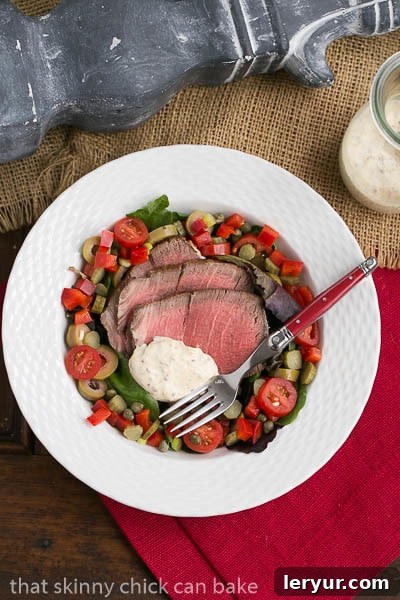 Close-up of Next-Day Beef Salad featuring tender slices of roast beef nestled among fresh vegetables and a creamy dressing.