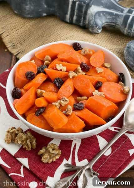 A bowlful of Orange Glazed Carrots on a red and white checkered napkin, ready to be served