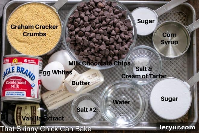 Gooey Smores Fudge Bars 3 Assorted S'mores Fudge Bar ingredients laid out on a sheet pan, labeled for easy identification.