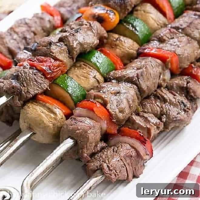 Grilled Teriyaki Beef - a flavorful marinade transforms this grilled beef into a magnificent entree Beef Teriyaki Kabobs on a white platter, beautifully arranged for serving.