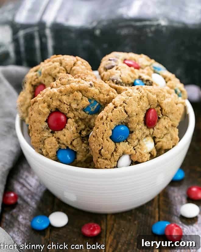 A twist on the classic oatmeal peanut butter monster cookies with patriotic M & M's for the holiday! Patriotic Monster Cookies in a white ceramic bowl