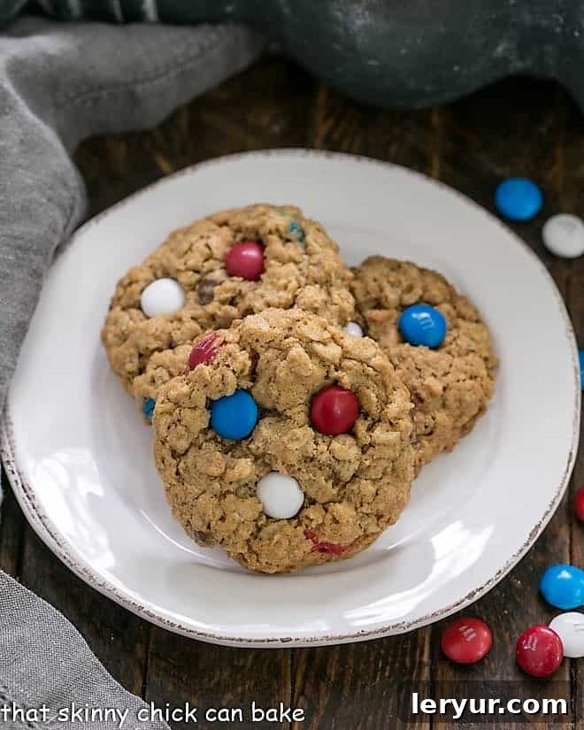 Patriotic Monster Cookies - Peanut butter oatmeal cookies chock-full of M&M's and chocolate chips Patriotic Monster Cookies on a small round white plate